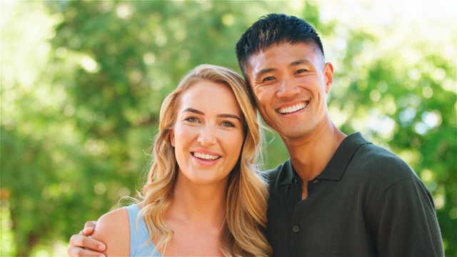 Happy Couple Smiling Together in Sunny Park During Summer Afternoon